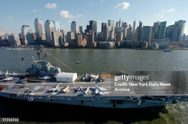 Tug boats guide the USS Intrepid down the Hudson River to Bayonne, N.J., where it will undergo a two-year, $60 million renovation. The historic...