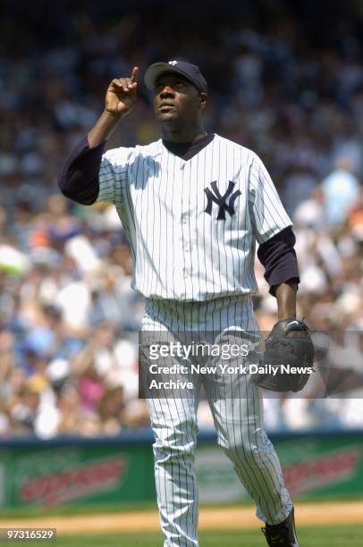 New York Yankees' starter Jose Contreras points skyward after retiring the side in the fourth inning with two runners left on base at Yankee Stadium....