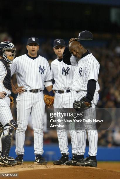 New York Yankees' starter Jose Contreras scratches his head as he waits to be removed from the game after the Boston Red Sox hit two home runs in a...