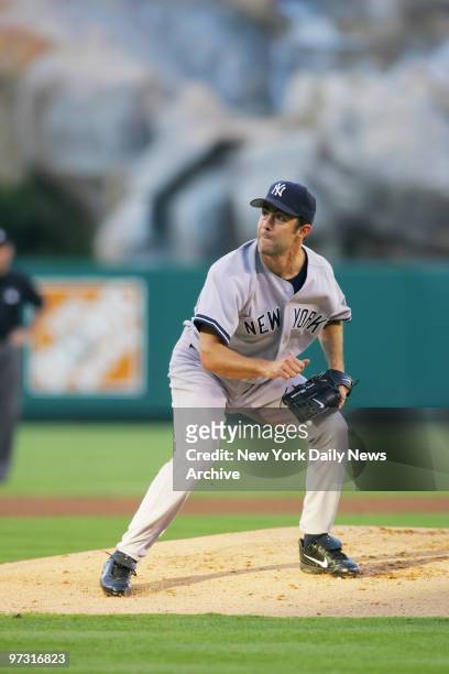 New York Yankees' starter Mike Mussina follows through on a pitch in the first inning of Game 5 of the American League Division Series against the...