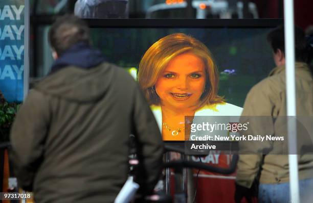Crewmembers watch a television monitor outside the "Today" show set in Rockefeller Center as Katie Couric announces she'll be leaving the show at the...