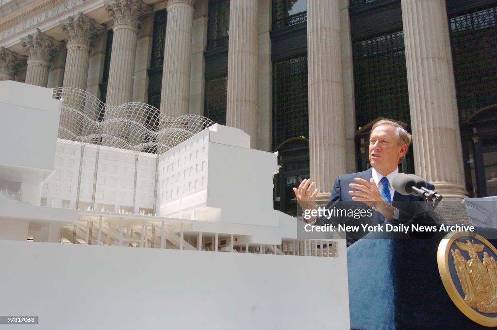 Gov. George Pataki speaks next to a model of Moynihan Statio
