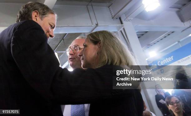 Gov. George Pataki speaks with Allison and Jefferson Crowther, who lost their son, Welles, in the 9/11 terrorist attack, during a news conference at...