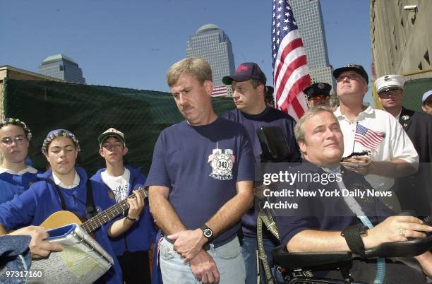 Steven McDonald, a New York City cop left quadriplegic by a gunshot wound that severed his spinal cord, sits in wheelchair as he and firefighters...