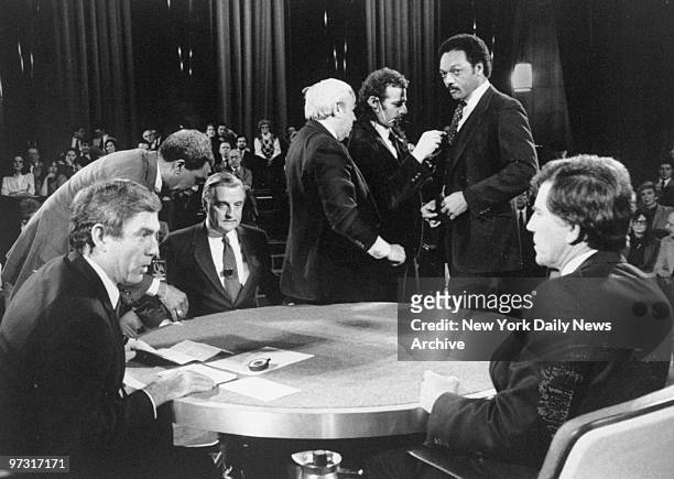 Newscaster Dan Rather with Democratic presidential candidates Walter Mondale , the Rev. Jesse Jackson and Gary Hart before debate at Columbia...
