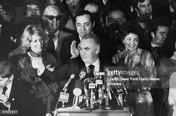 Gov. Hugh Carey, after his re-election victory, speaks to crowd while Anne Ford, Mario Cuomo and Mrs. Matilda Cuomo cheer him on.