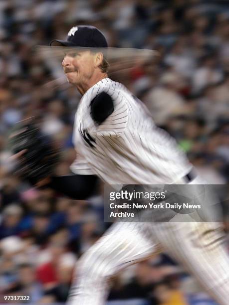 New York Yankees' starter Randy Johnson delivers a pitch in a blur during the eighth inning against the Pittsburgh Pirates at Yankee Stadium. Johnson...