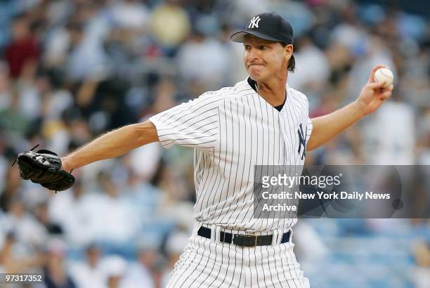 New York Yankees' starter Randy Johnson delivers a pitch in the first inning of a game against the Atlanta Braves at Yankee Stadium. Johnson struck...