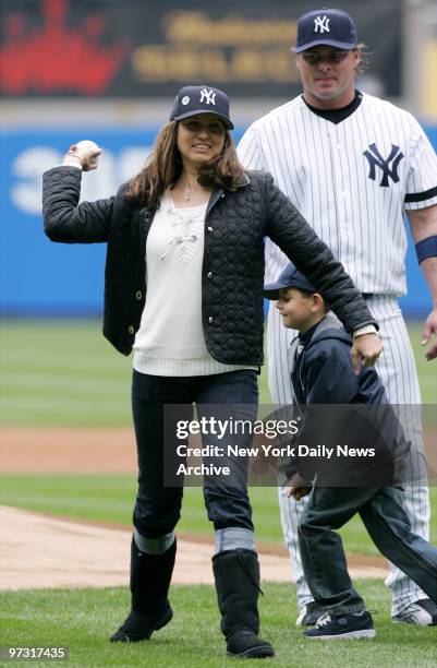 Melanie Lidle, widow of the late Corey Lidle, throws out the ceremonial first pitch as son Christopher and New York Yankees' Jason Giambi look on...