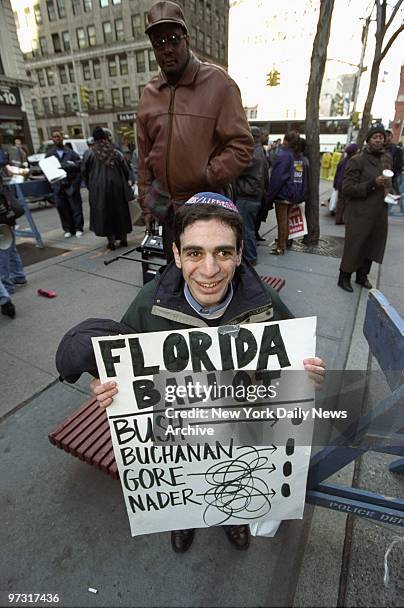 Twenty-nine-year-old Ariel Kohane, wearing a Gore-Lieberman yarmulke, holds a sign representing the confusion involving the so-called butterfly...