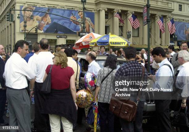 New Yorkers try to make the best of it as they try to get home during the blackout. People gathered around SUV to listen to the latest news on radio...