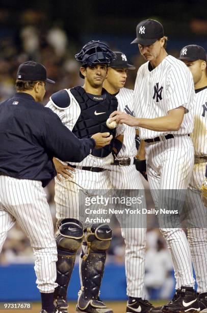 New York Yankees' starter Randy Johnson gives the ball to manager Joe Torre after being relieved in the eighth inning of a game against the Tampa Bay...