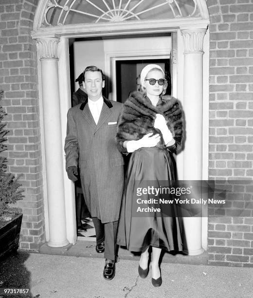 Grace Kelly, clad in a mink stole and topped off with a pink straw turban, leaves for Rita Gam wedding.