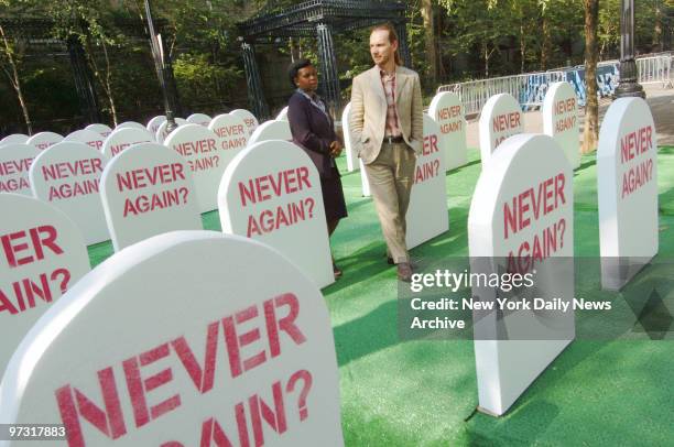 Grace Mukagabiro , a Rwandan genocide survivor, and Kemal Pervanic, a Bosnian Muslim who survived the Omarska prison camp, walk through a mock...