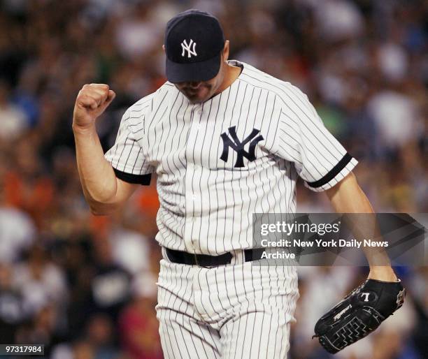 New York Yankees' starter Roger Clemens pumps his fist after getting a strike out to end the top of the eighth inning of a game against the Minnesota...