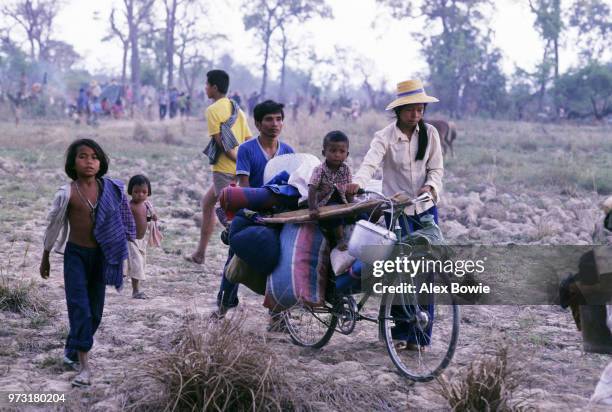 Cambodian refugees flee to the safety of Thailand, as fighting between the Vietnamese army and Khmer resistance forces rages closer to the Thai...