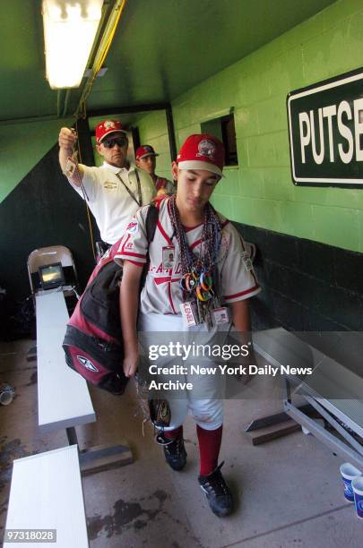 Staten Island's catcher Robert Ortiz is dejected as he carries equipment from the dugout after losing to Phoenix, 4-1, during the Little League World...