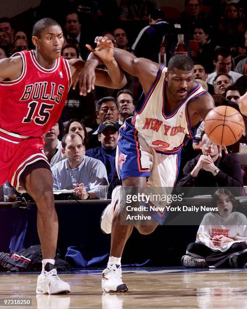 New York Knicks' Larry Johnson and Chicago Bulls' Ron Artest chase a loose ball during game at Madison Square Garden. The Knicks won the game, 95-88.