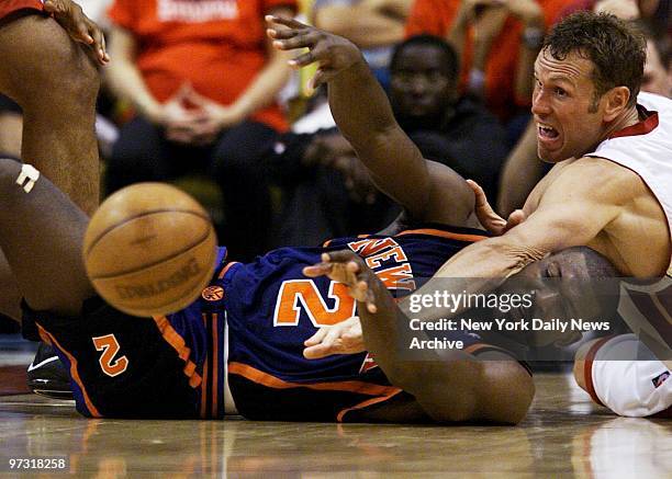 New York Knicks' Larry Johnson and Miami Heat's Dan Majerle reach for a loose ball in Game 1 of the NBA Eastern Conference playoffs in Miami. The...