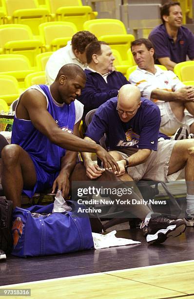 New York Knicks' Larry Johnson has his knee attended to at practice session for Game 2 of the Eastern Conference playoffs against the Miami Heat at...