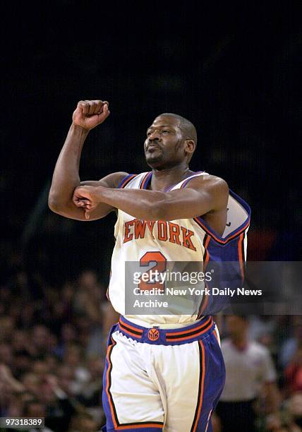 New York Knicks' Larry Johnson makes L sign with his arms after making a three point shot during game against the Miami Heat. The Heat won, 77-76 to...