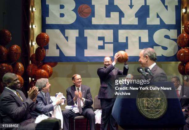 Developer Bruce Ratner wields a basketball as former NBA star Bernard King, Brooklyn Borough President Marty Markowitz, Gov. George Pataki, Sen....