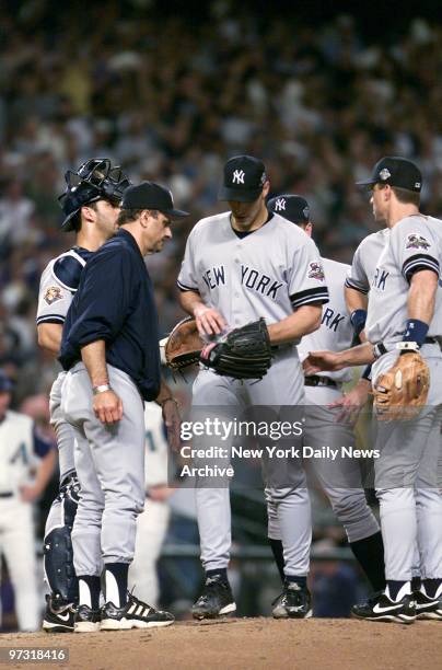 New York Yankees' starting pitcher Andy Pettitte hangs his head as he is removed from the game by manager Joe Torre in the third inning of Game 6 of...