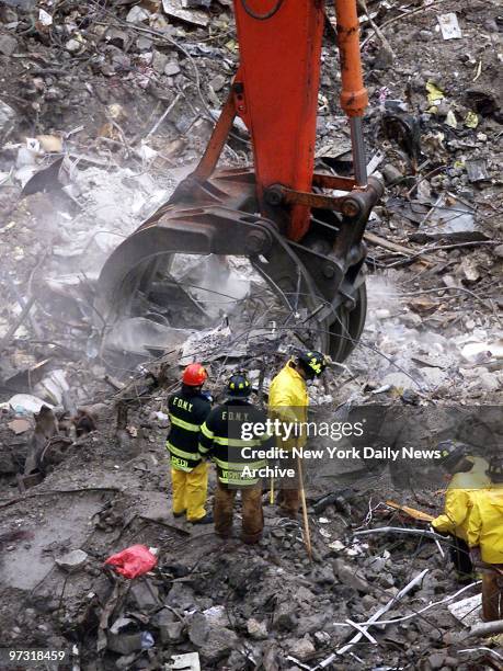 Digging carefully at the site of the collapsed lobby of the South Tower, workers continue to search for the bodies of victims of the attack on the...