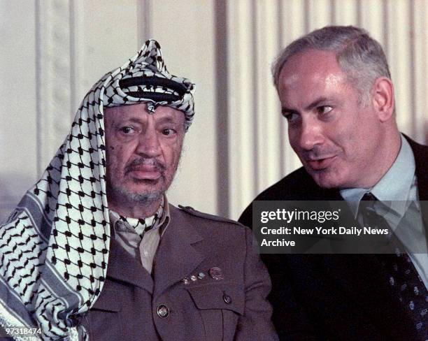 During a press briefing in the East Room of the White House, Wednesday, Yasser Arafat sat stone faced as Israeli Prime Minister Benjamin Netanyahu...