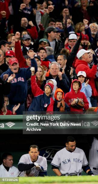 New York Yankees' third baseman Alex Rodriguez and shortstop Derek Jeter sit glumly in the dugout at Fenway Park during the ninth inning while Boston...