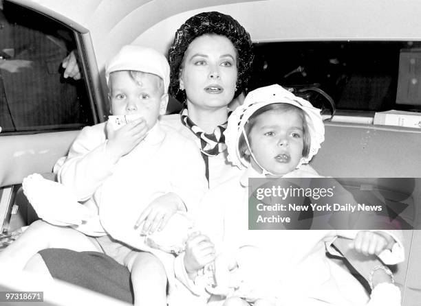 Gracing the Scene. Princess Grace of Monaco holds Prince Albert and Princess Caroline as she leaves International Airport after flight here from...