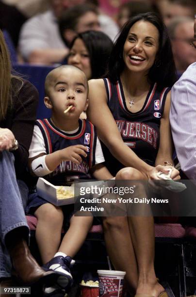 Two of Jason Kidd's biggest fams, his wife, Joumana, and 3-year-old son, Trey Jaxon, watch as their hero lesds the New Jersey Nets to a 99-93 win...