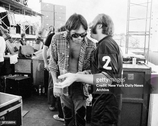 Stephen Stills and Neil Young talk backstage before a Crosby, Stills, Nash, and Young concert.
