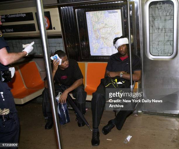 Two passengers with head injuries receive medical attention after three cars of a southbound B train derailed at Flatbush and DeKalb Aves. Injuring...