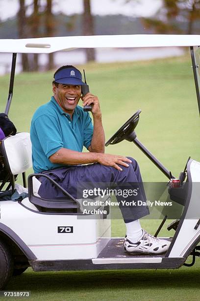 Simpson keeps in touch in his golf cart.