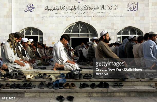 Steps of the Blue Mosque in Kabul, Afghanistan, are strewn with shoes as men worship during a Friday prayer service.