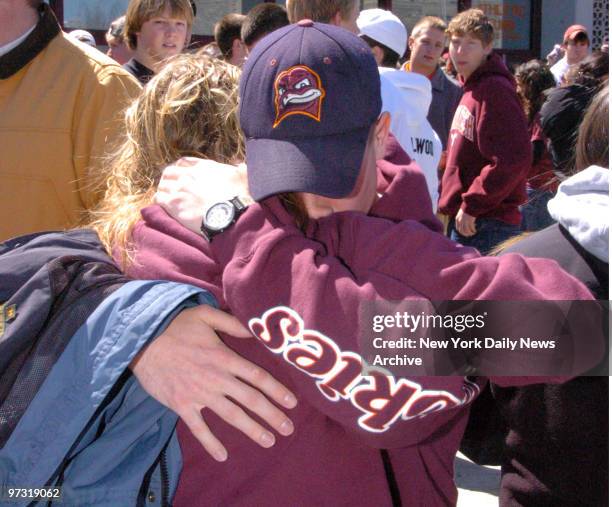 Two Virginia Tech students hug outside Cassell Coliseum as people file into the hall to attend a memorial service for those who died in yesterday's...