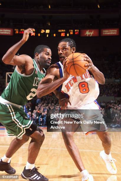 New York Knicks' Latrell Sprewell drives past Boston Celtics' Erick Strickland during game at Madison Square Garden. Despite Sprewell's 49 points,...