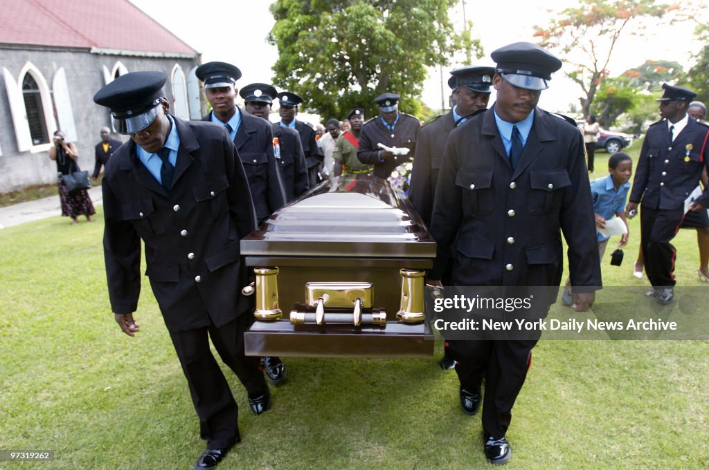 Members of the local Fire Department carry coffin during fun