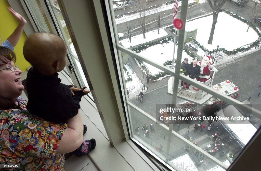 Two-year-old Kayla Caesar, from Brooklyn, watches as Santa C