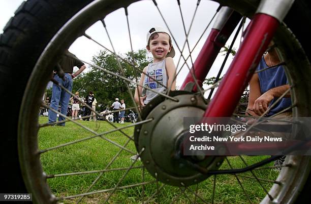 Two-year-old Kyle Schepis is old enough to admire a 1971 Harley Davidson at the Antique Motorcycle show at the Queens County Farm Museum on Little...