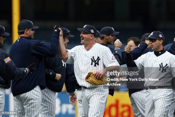 New York Yankees' starting pitcher David Wells gets high-five from teammates as he celebrates his 2-0 shutout against the Minnesota Twins at Yankee...