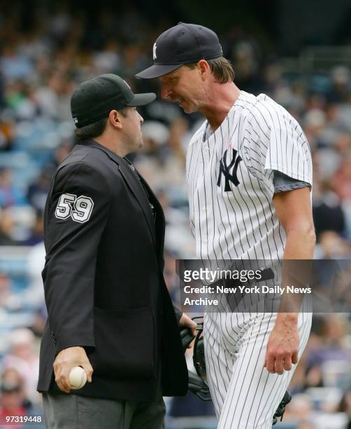 New York Yankees' starting pitcher Randy Johnson has words with home plate umpire Tony Randazzo during the fifth inning of a game against the Oakland...