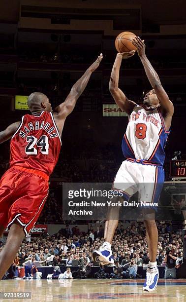 New York Knicks' Latrell Sprewell shoots over Miami Heat's defender Jamal Mashburn at Madison Square Garden.