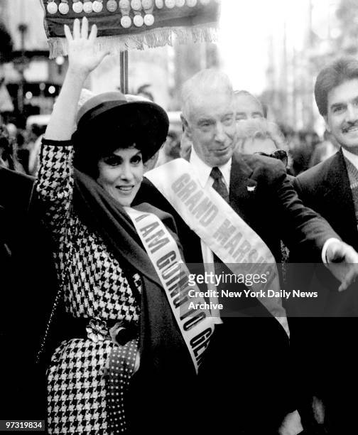 Grand Marshals Gina Lollobrigida and Joe DiMaggio salute crowd during the Columbus Day Parade.