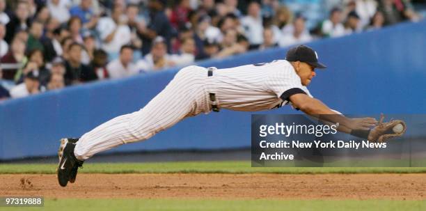 New York Yankees' third baseman Alex Rodriguez makes a diving stop on a ball - though the runner was called safe at first - in the third inning of a...