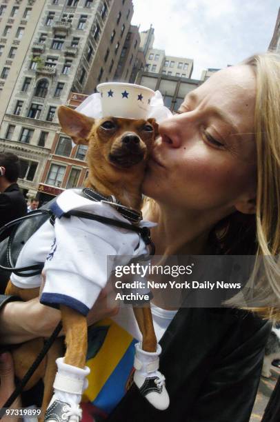 Karen Biehl smooches her 2-year-old Chihuahua, Eli, who's dressed in sailor garb in honor of Old Navy and Fleet Week, as the two wait in line to get...