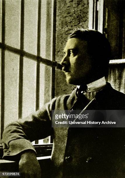 Adolf Hitler looking out of the bars on the window to his prison cell at Landsberg Prison. In 1924 Adolf Hitler spent 264 days incarcerated in...