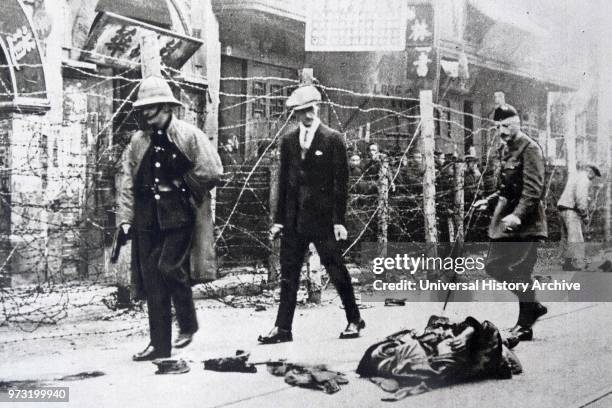 British consular officials inspect scene of Massacre in Canton. China 1925.On June 21. 1925. Workers in Hong Kong and Canton went on strike. Two days...