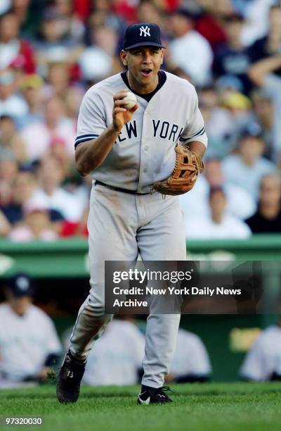 New York Yankees' third baseman Alex Rodriguez shows off a pop fly hit by Boston Red Sox's Tony Graffanino after nearly bobbling it in the ninth...